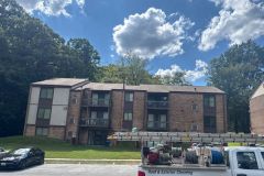 Years of dirt and algae buildup covered the apartment roof before our cleaning process.