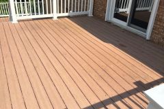 Power washing a weathered deck