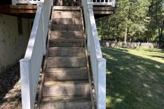 Dark patches of mildew covered the deck’s surface.