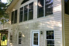 Mold-covered front of house before exterior cleaning service